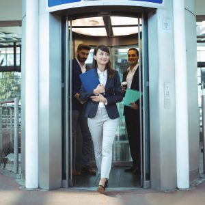 Smiling business executives coming out from lift